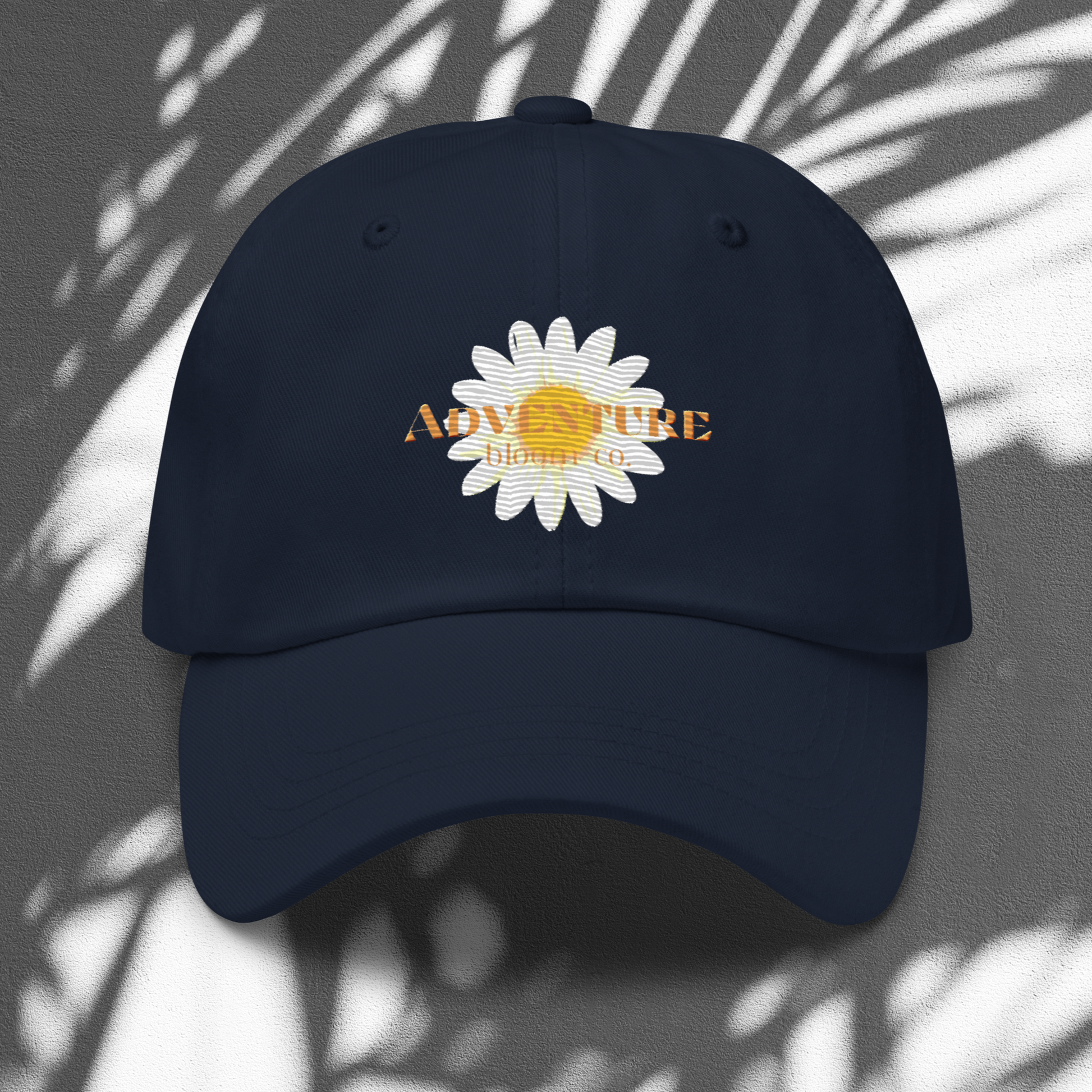 A close-up view of the Wild Bloom Baseball Cap in Navy by Adventure Bloom Co.