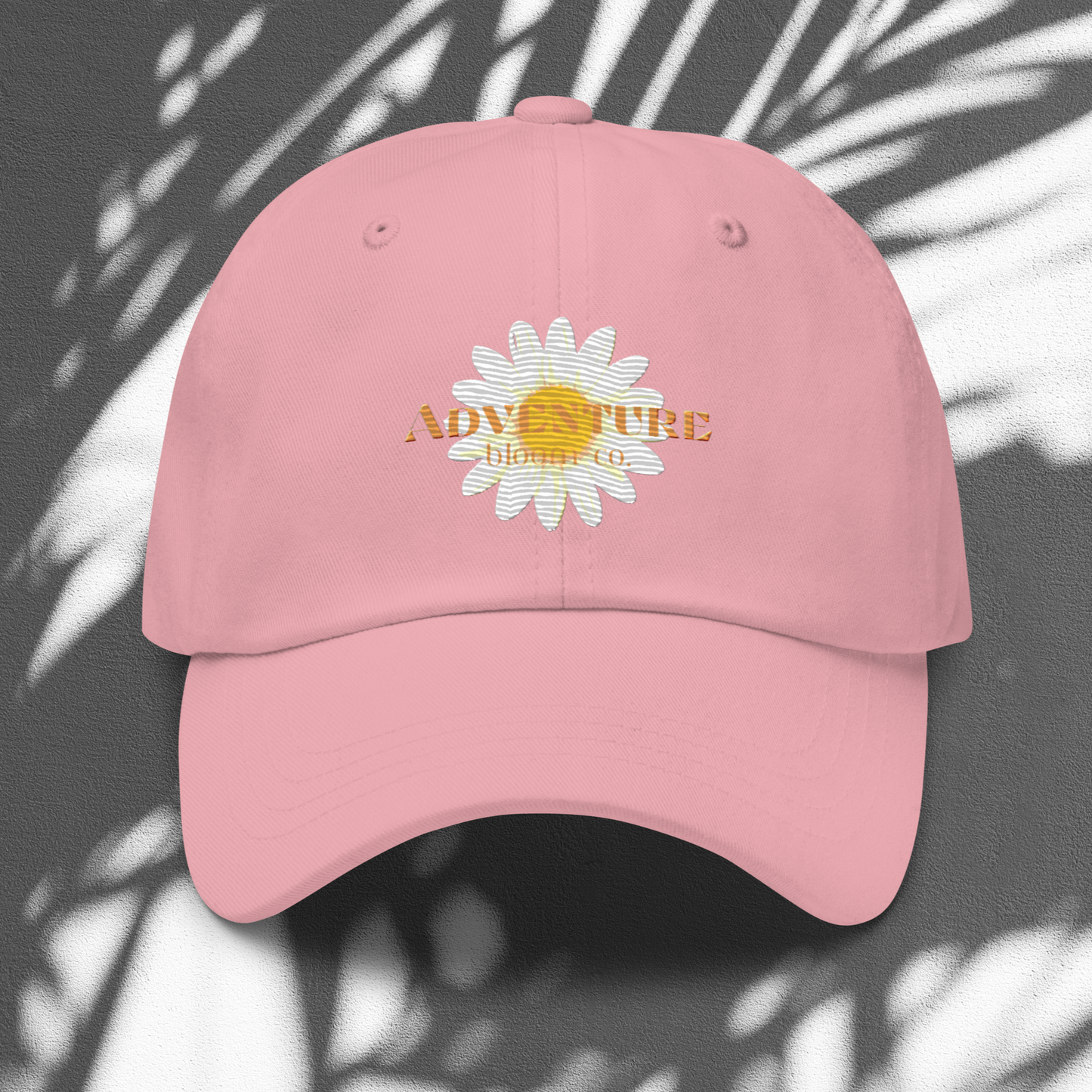 A close-up view of the Wild Bloom Baseball Cap in Pink by Adventure Bloom Co.