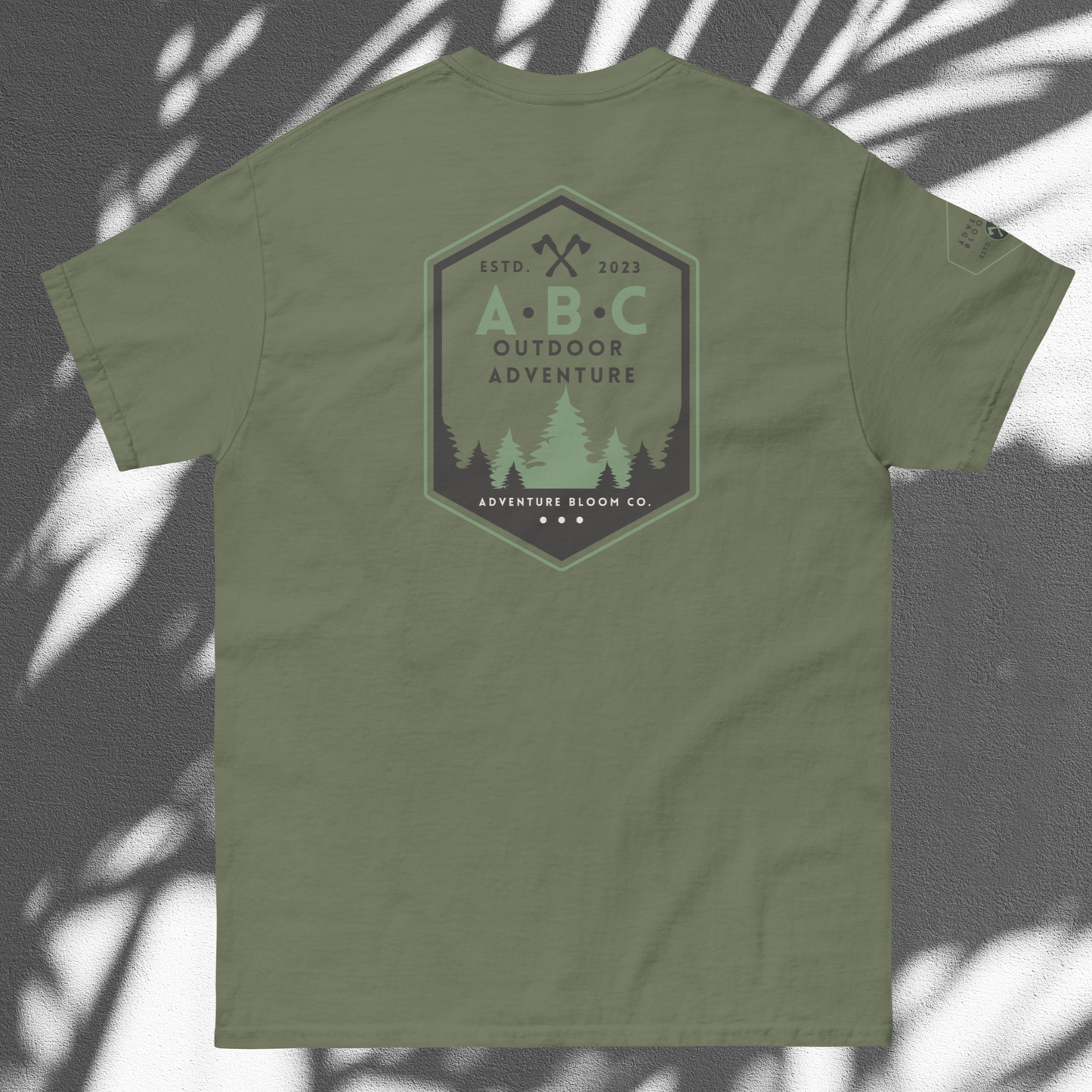 Lay Flat View of Adventure Bloom Co. Axe-Masters Adventure Tee in Military Green