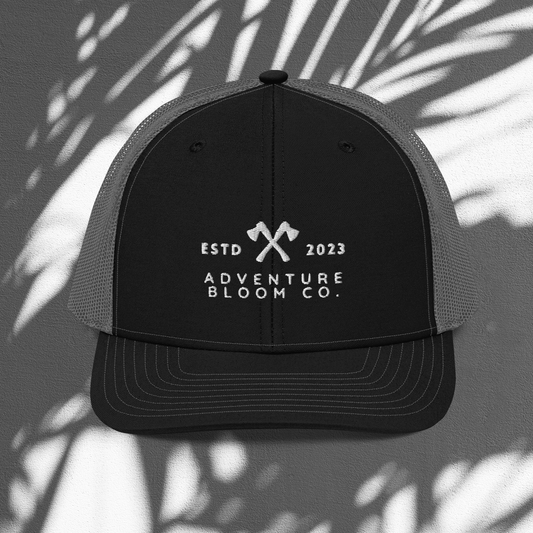 Axe-Masters Trucker Cap in Black Charcoal with an adventure-themed design.