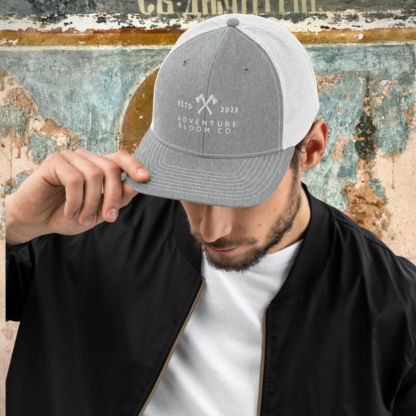 Men's trucker cap in Heather Grey featuring the thrill of carving your adventure.