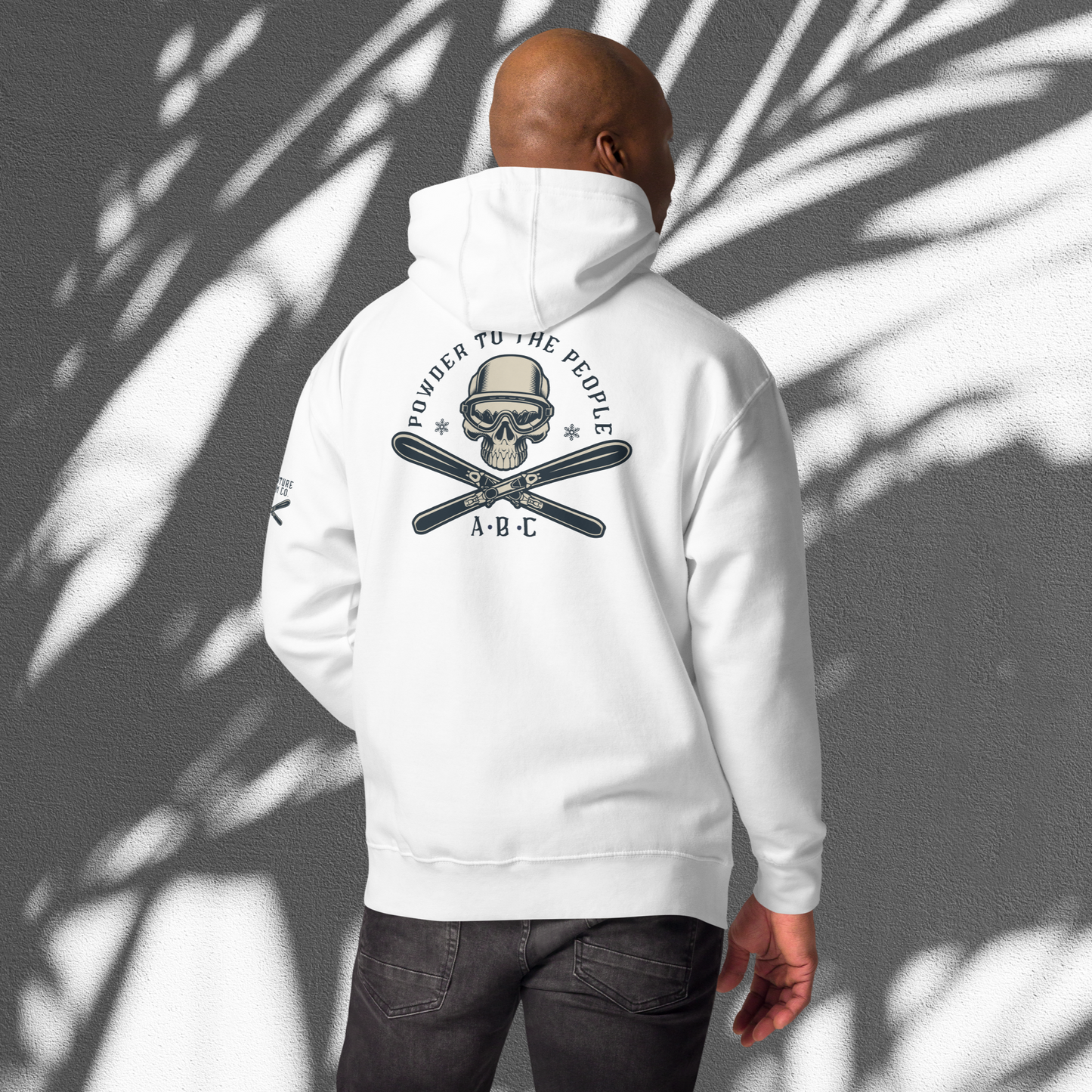 Ski enthusiast embracing the thrill of Adventure Bloom Co.'s hoodie design in White.