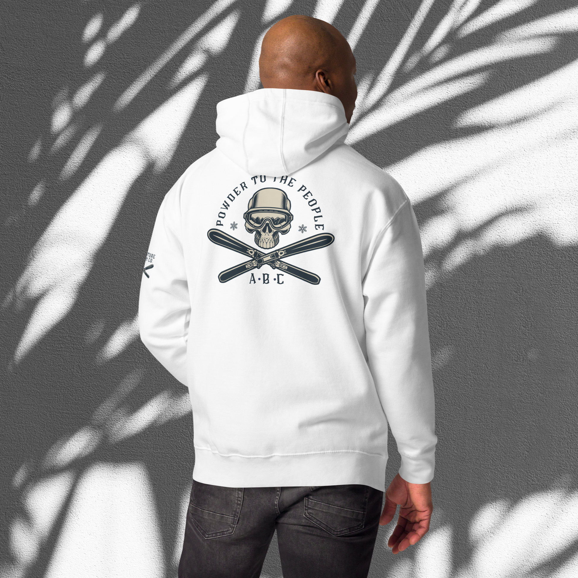 Ski enthusiast embracing the thrill of Adventure Bloom Co.'s hoodie design in White.